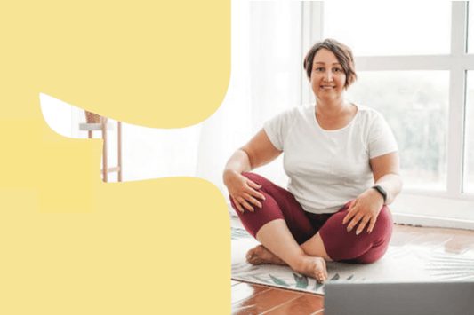 Woman sitting on yoga mat