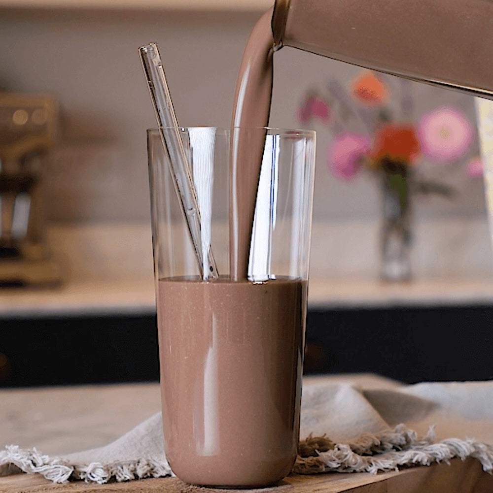chocolate meal replacement shake pouring into glass