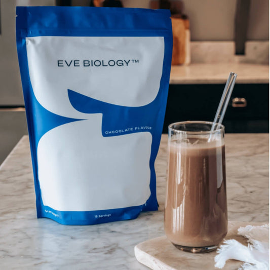 Eve Biology chocolate-flavoured powder package next to shake on a kitchen counter.