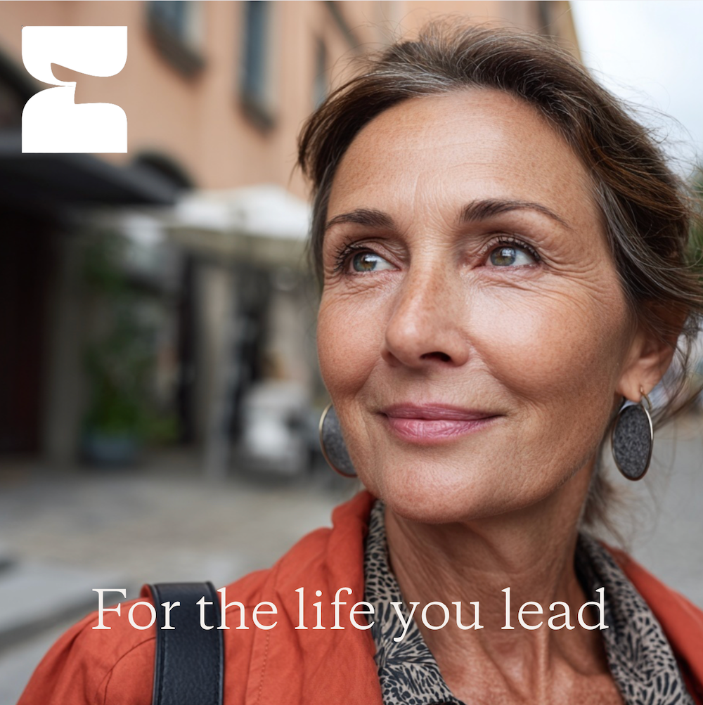 Woman with a neutral expression outdoors, with text 'For the life you lead' and a logo.