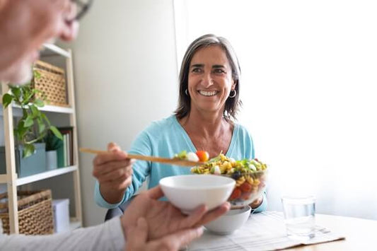 Woman in a blue top having a healthy lunch