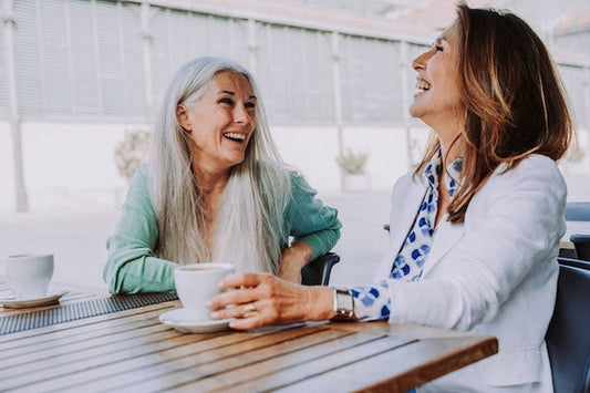Two women in midlife having tea together