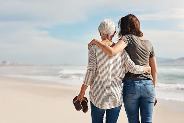 Two women walking on beach