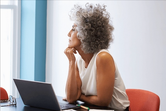 Mature woman looking out of a window