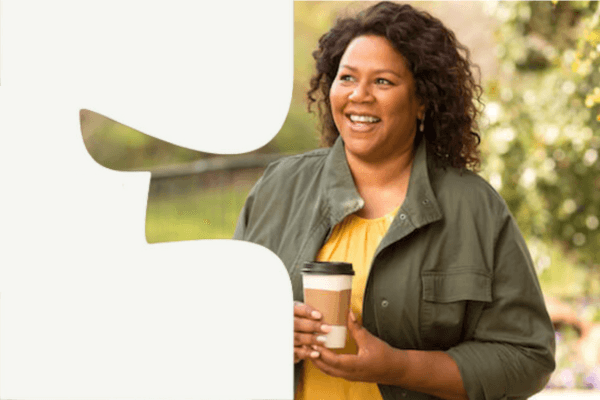 Woman walking outside with coffee