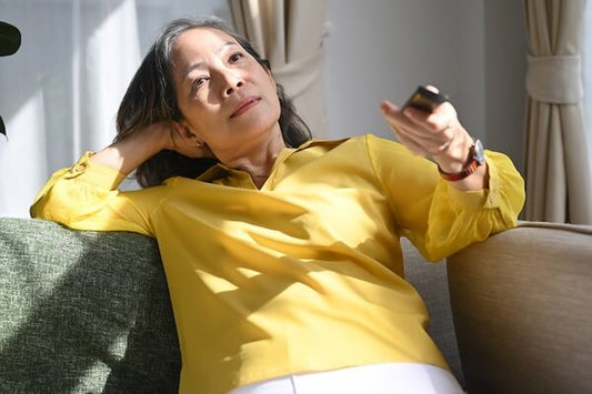 Woman watching tv, yellow blouse
