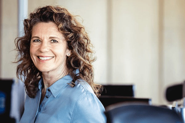 Smiling woman in blue shirt