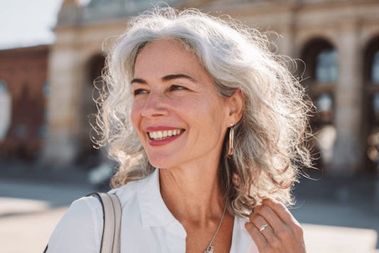 Woman in white shirt, grey hair