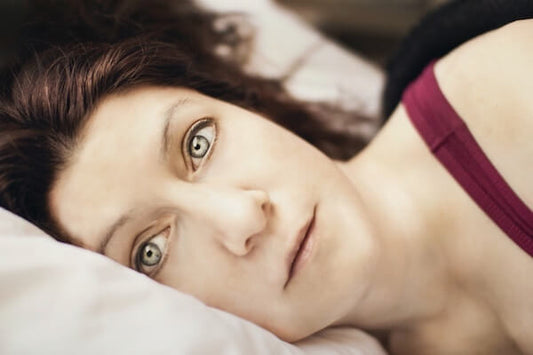 Woman lying in bed awake