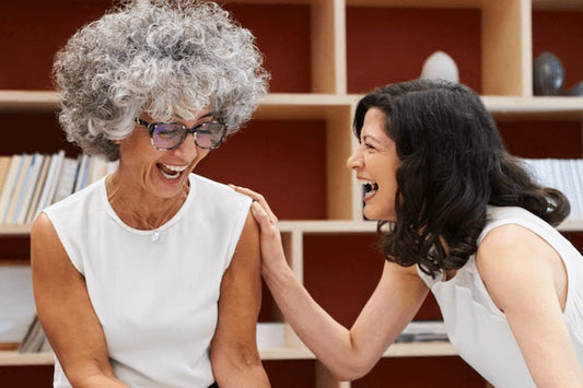 Two women laughing together at work