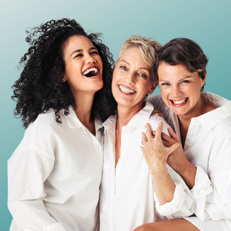 women in white shirts, laughing together, high energy