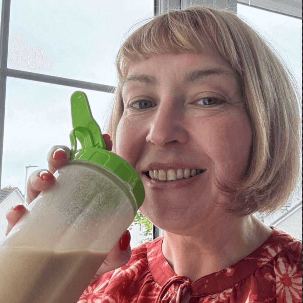 Eve customer holding a green and white protein shaker