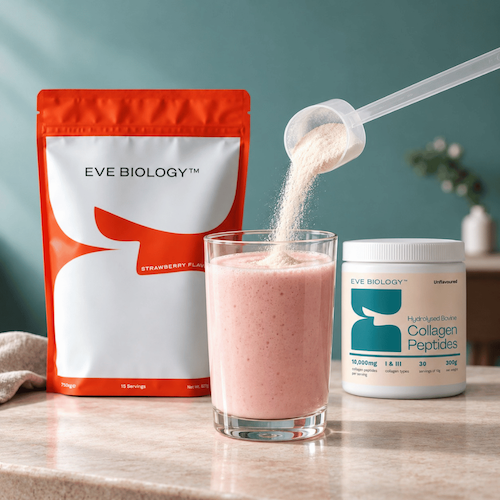 A glass of strawberry shake with collagen powder being poured into it, alongside a red and white bag of Eve Biology Strawberry Protein Powder and a white tub of Eve Biology Hydrolysed Collagen Peptides on a countertop against a teal wall.