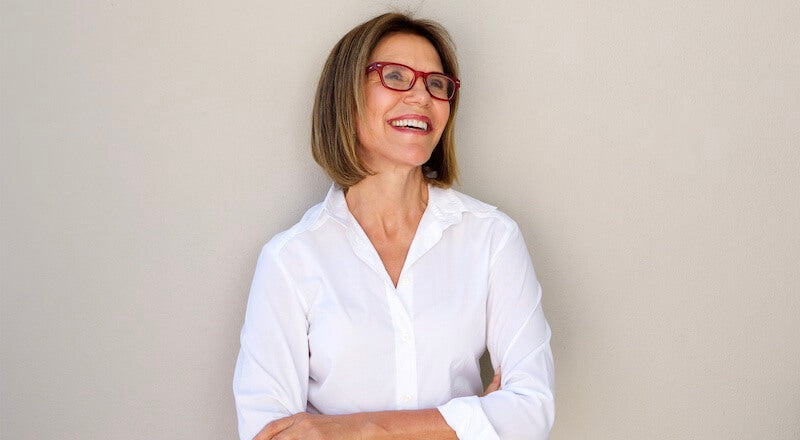 woman in red glasses and white shirt
