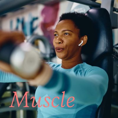woman in blue top doing chest exercises in a gym