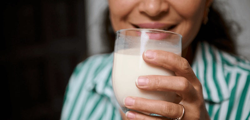 Woman holding a vanilla shake with a blurred background