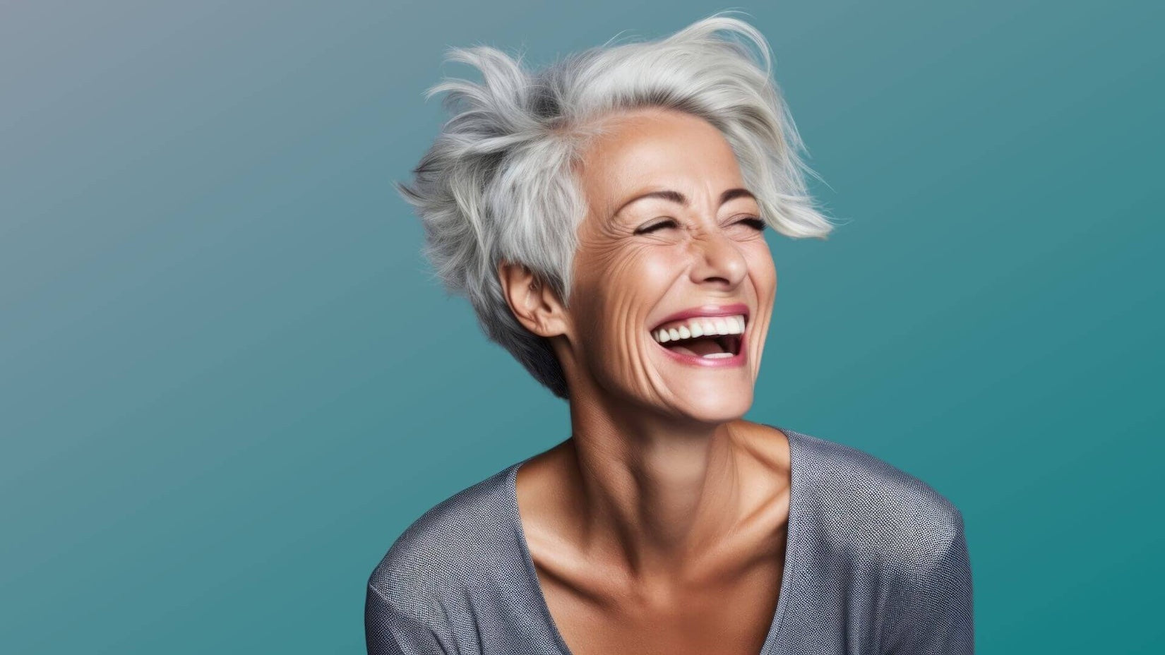 Laughing mature woman on a plain background