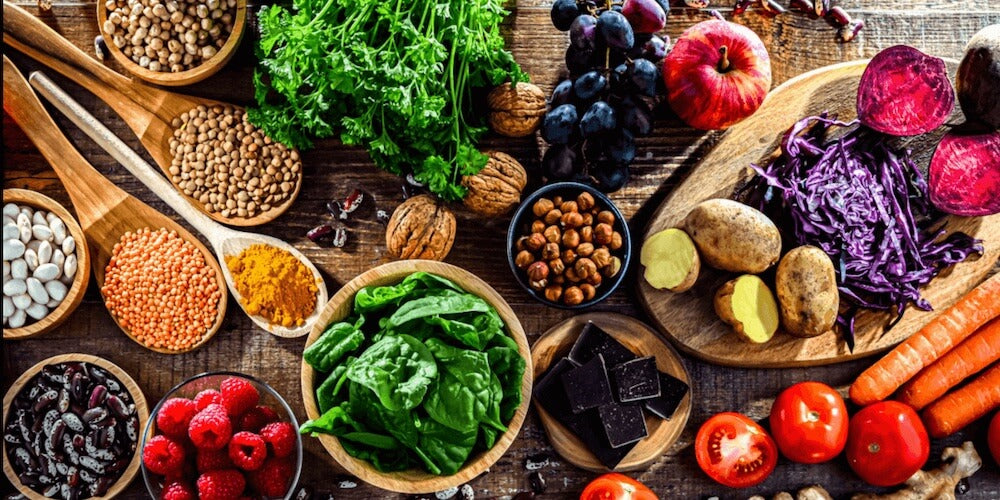 Fresh vegetables, grains and herbs on a natural background
