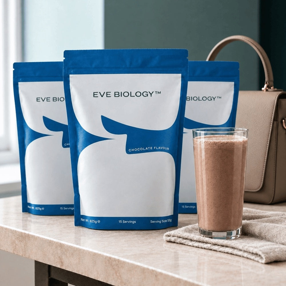 three blue pouches of Eve Biology shake on a marble counter with a woman's handbag in the background