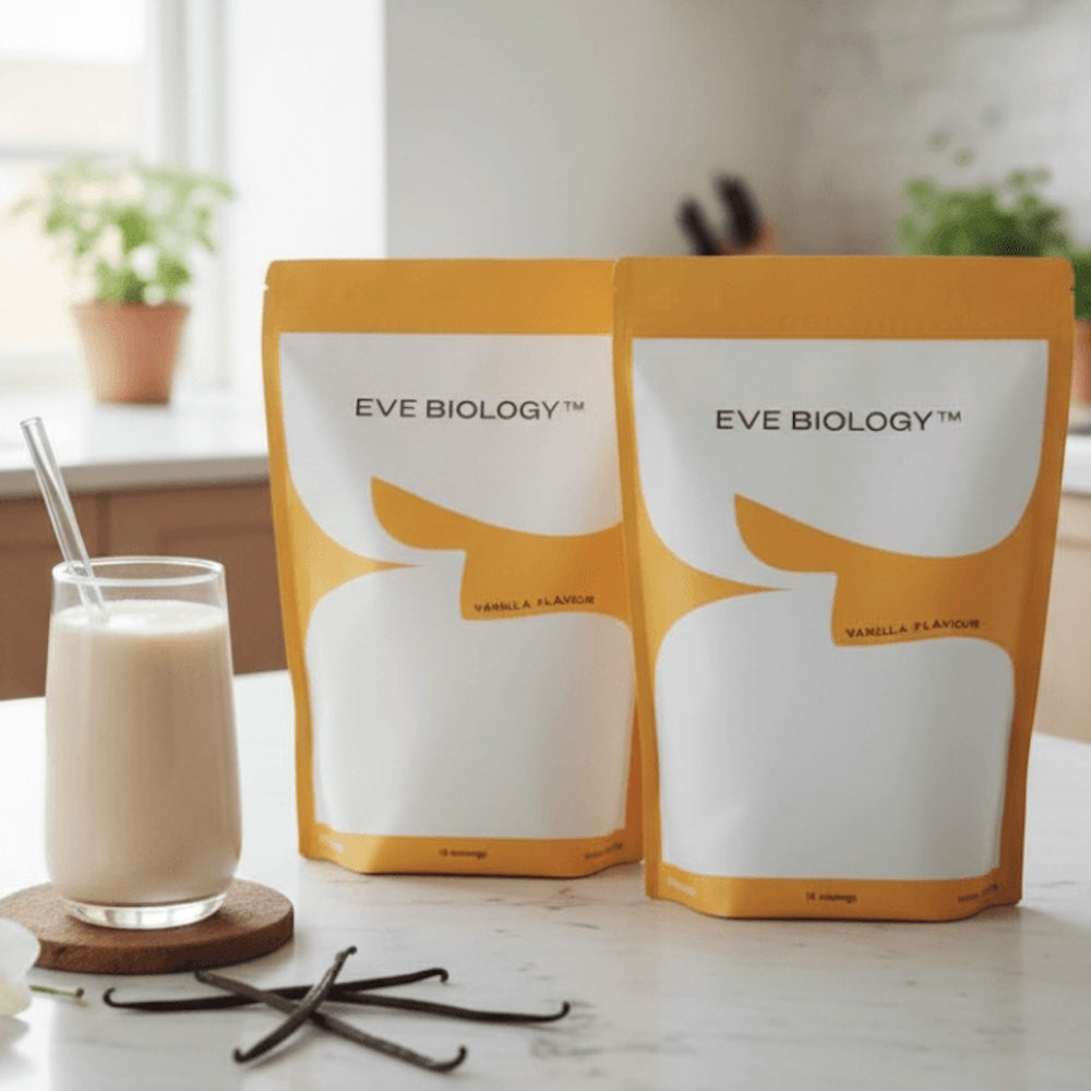 Two packages of Eve Biology vanilla-flavored product on a kitchen counter with a glass of the product.