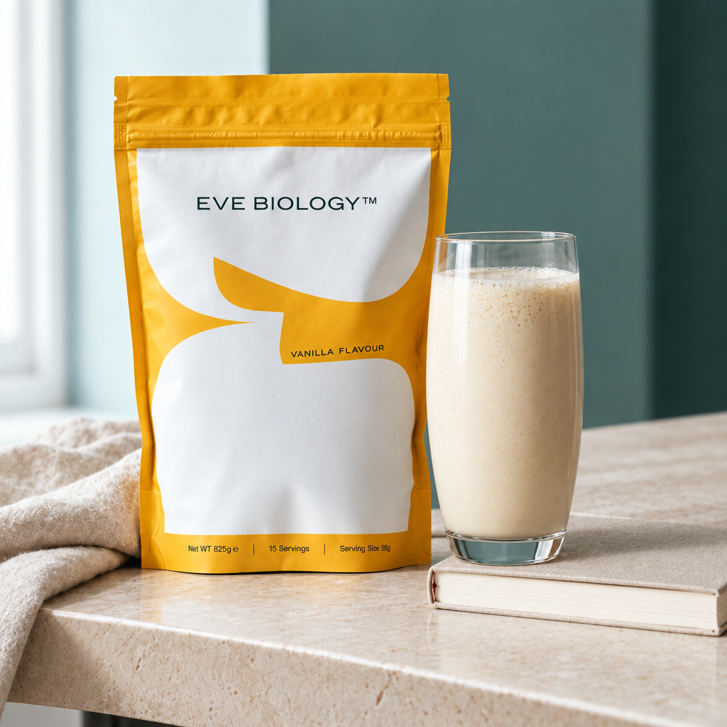 Vanilla shake in tall glass close-up, pouch and glass together, teal background