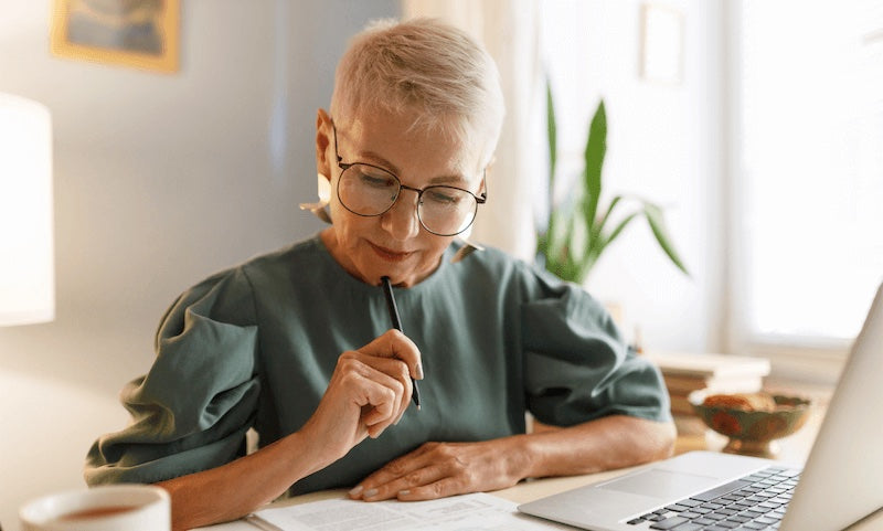 women in a green dress and glasses